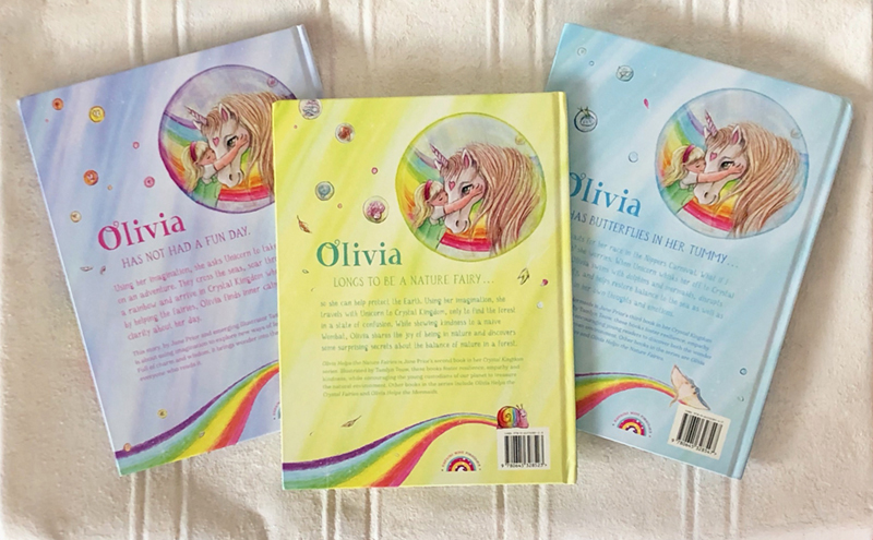 three back covers fanned out with a girl and her unicorn on them